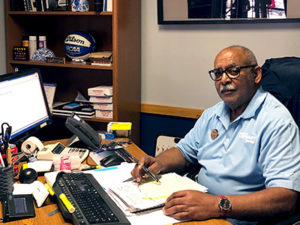 Bill Gardner, General Manager at Car-Mart of Camden, sitting at his desk