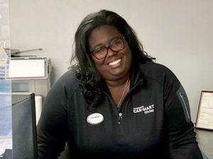 Jaqueeta Jones, Car-Mart Area Operations Manager, in the payment office of a dealership.