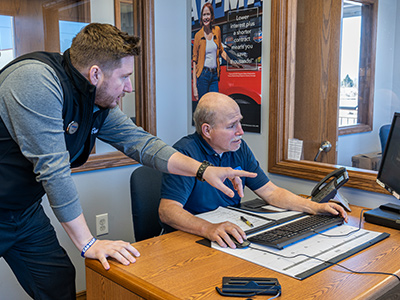 Ryan Human, Car-Mart's Director of Associate Development, teaching a Future Manager on using a Car-Mart program