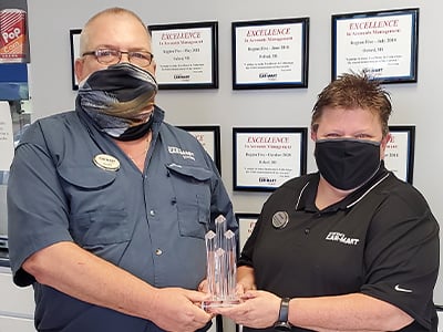 Pat receiving the Mentor of the Year Award from her Area Operations Manager, Blake North